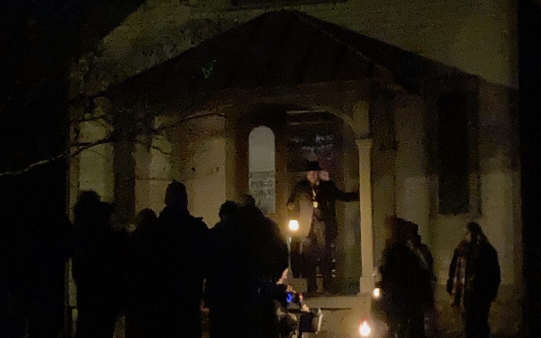 people gathered at a building with lanterns