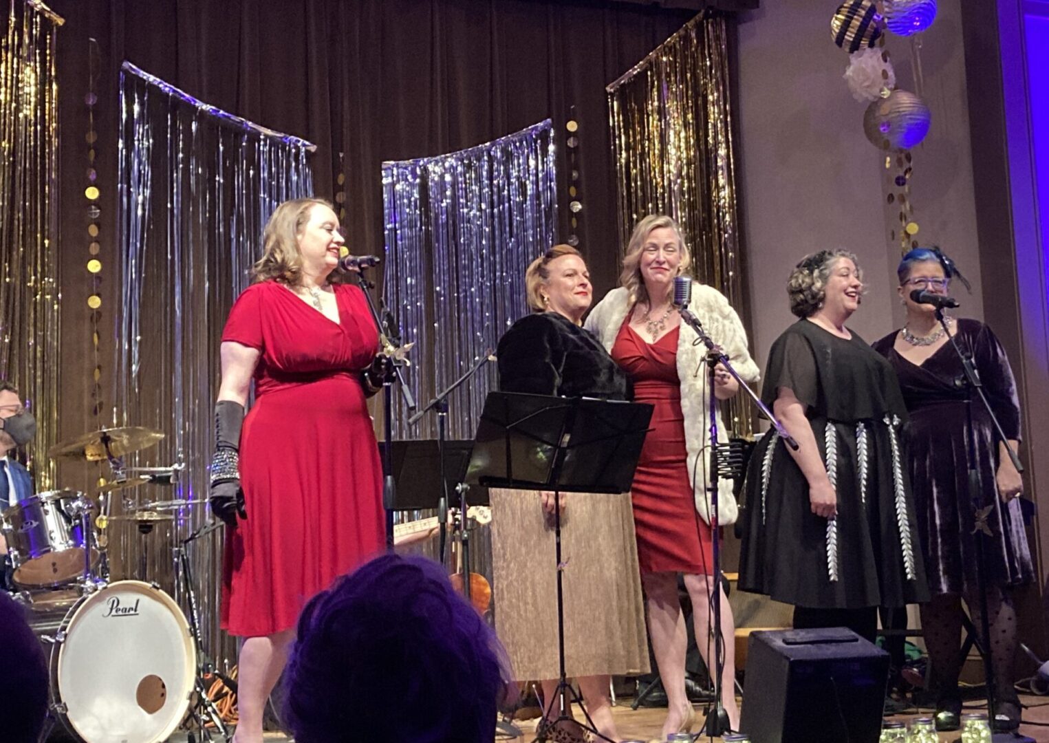 A Group of Women Singing on a Decorated Stage