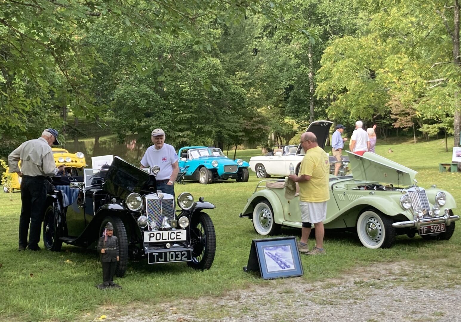 Men checking out vintage cars