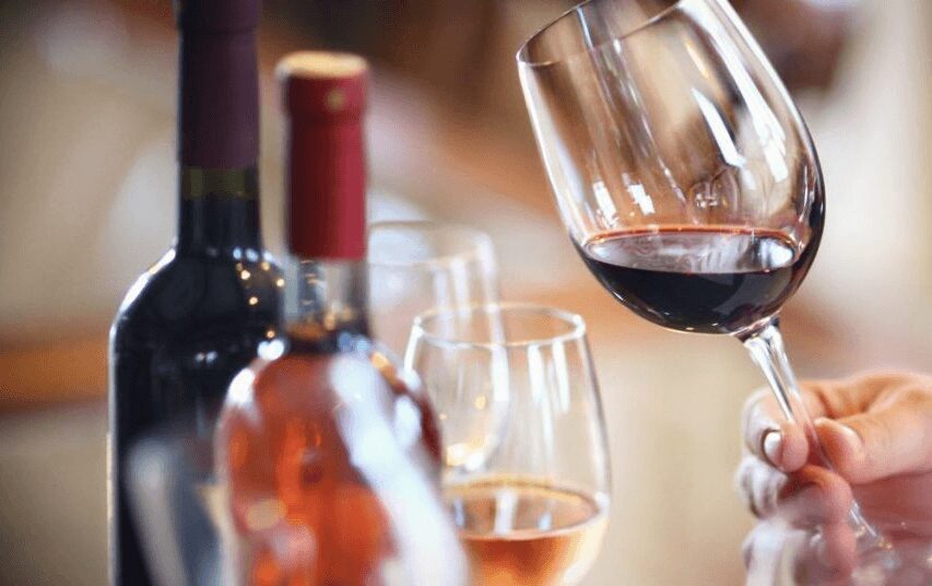 Wine glasses and bottles on a table.